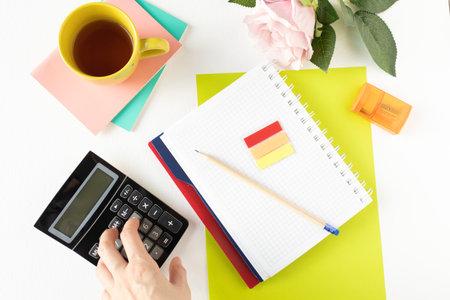 Work with documents. Notebook, pen, notebook, calculator, financial documents, a cup of cappuccino coffee on the table.の写真素材