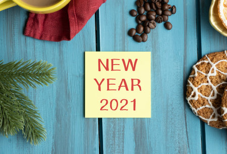 New Year 2021 text on yellow paper on a Christmas table decoratedの写真素材