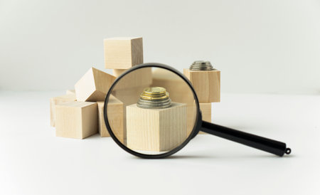 close-up shot of wooden blocks with JOBS sign and magnifying glass on tableの写真素材