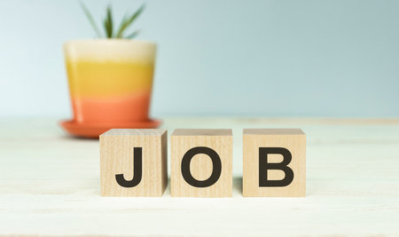 The word Job, alphabet on wooden cubes. Background copy space, minimal. Job application process, creating safe job procedures and work practices for employee and human resources.の写真素材