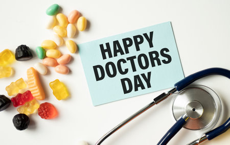 Doctor's Day concept. Medical apparatus such as stethoscope and spiral notepad with Happy Doctors' Day text on it. Flat lay view.の写真素材