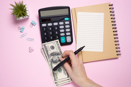 Tax 2021 business finance concept. Calculator with money and Form 1040 on table.Annual tax payment