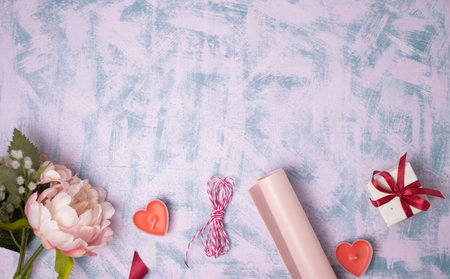 Valentine's Day background. Gifts, candle, confetti, envelope on pastel blue background. Valentines...