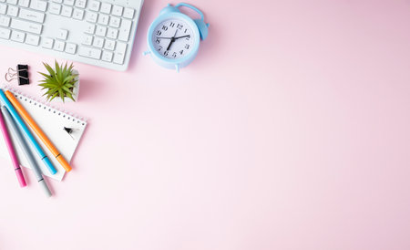 feminine banner or shop header with office writing supplies, technical gadgets, smartphone and a bunch of pink flowers on a pink background copyspace for your text and branding top viewの写真素材