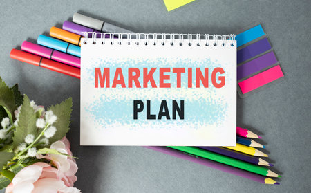 Notebook with Tools and Notes about Marketing Plan, business concept.の写真素材