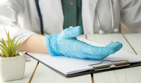 Doctor advising patient in hospital office, medical conceptの写真素材