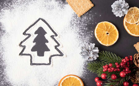 Christmas Tree Made From Flour On A Dark Table, Frozen Cranberry And Dried Fruitsの写真素材