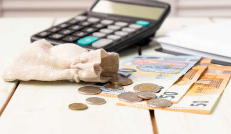 Euro banknotes and coins with bills to payの写真素材
