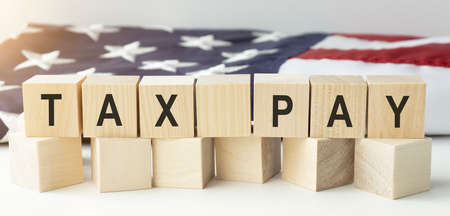 TAX PAY word made with wood building blocksの写真素材