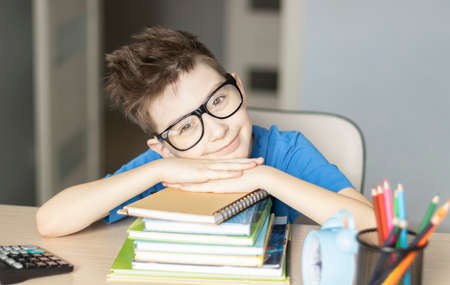 Cute little boy doing homework. Child learning foe school.の写真素材