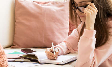 pretty woman with digital tablet sitting in chair at homeの写真素材