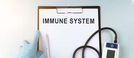 Medical concept - pressure gauge with notepad and notepad for recording the immune systemの写真素材
