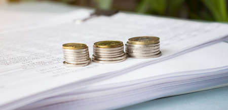 Silver pen lying over financial statistics paper with set of numbersの写真素材