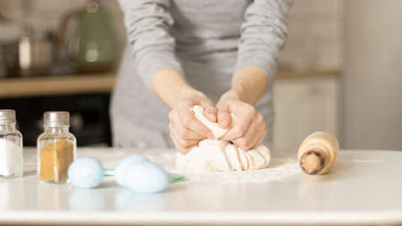Making Easter cookies, female hands with doughの写真素材