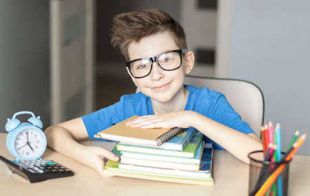 Cute little boy doing homework. Child learning foe school.