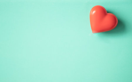 Red wooden heart on turquoise background.の写真素材
