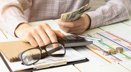 Accountants calculating profit - closeup shot of hands counting money