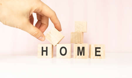 Home word cube isolated on wooden backgroundの写真素材