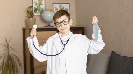 Cute Kid Boy Wear Medical Uniform Playing Doctor, Portraitの写真素材