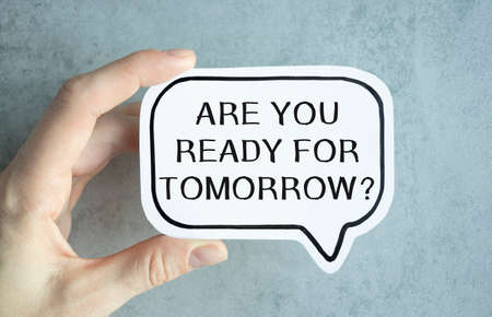 Closeup on businessman holding a card with text ARE YOU READY FOR TOMORROW, business concept image...