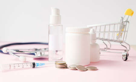 stack of coins with medicine bottle on the white backgroundの写真素材