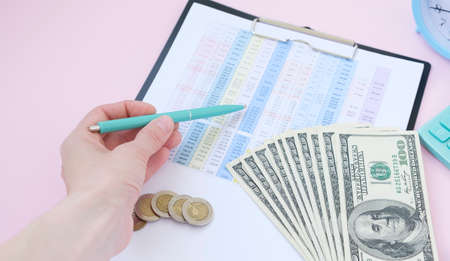 businessman working on desk office with using a calculator to calculate the numbers, finance accounting conceptの写真素材