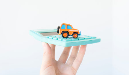 Typewriter on a calculator in hand. Car insurance concept.