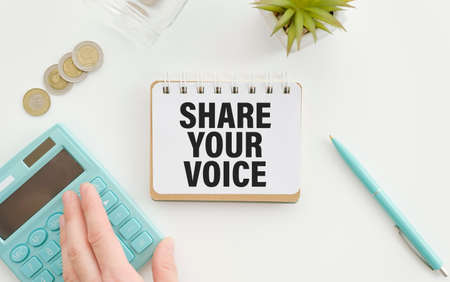 note with the message of share your voice, with desk backgroundの写真素材