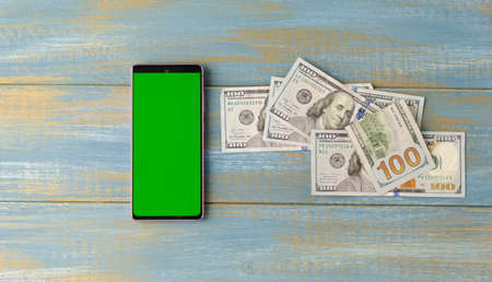 green screen lies on a blue background with american money dollarsの写真素材