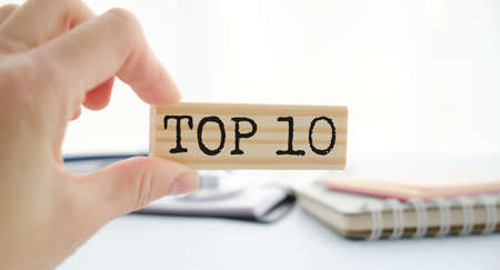 Top 10 sign made of wooden dices on a table ia bright environment with blue colorsの写真素材
