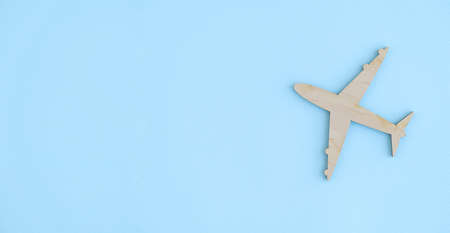 Model of a toy airplane of white color on a blue background with place for adding text, concept of...