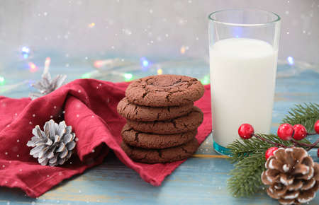 Cookies and milk for Santa Clause on wood background