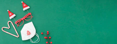 top view of a Christmas holiday green background concept Christmas balls and Christmas decorations on green color paper backgroundの写真素材