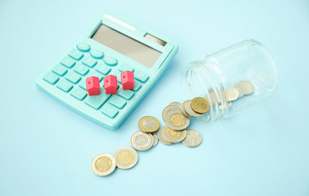 house, gold coins and calculator for mortgage loan conceptualの写真素材