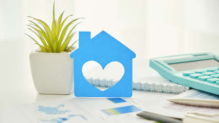 Real Estate Concept Paper model house with keys against white blue print. Ecological building. Top view.の写真素材