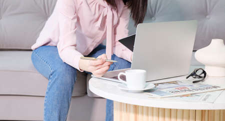 Finance workers are reviewing the company's financial data on a laptop and using smartphones to communicate or chat with the team at social distancesの写真素材