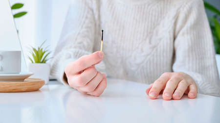 Fatigue from work. Work from home. Remote work. A burnt match in the girl's hand. The concept of...