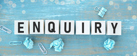 Enquiry word written on wooden blocks on wooden table.