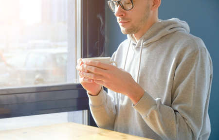 businessman, freelancer relaxed, drinking morning coffee at home office.