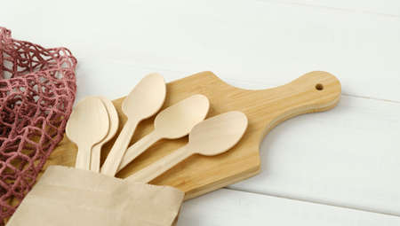 Eco friendly tableware, zero waste. Wooden spoons Eco concept on wooden background. Eco pine wood...