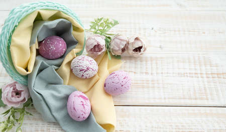 Easter Eggs on Wooden Background. Congratulatory easter background. Easter eggs and flowers.