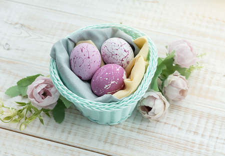 Easter eggs in the nest on rustic wooden background.の写真素材