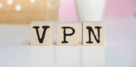 a wooden blocks with the letters VPN written on it on a white background. VPN - short for Virtual Private Network.の写真素材