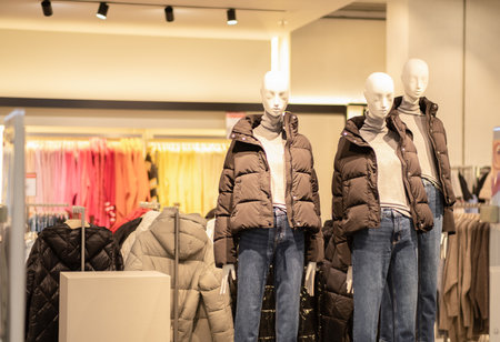 Fashion shop window decoration for cold season. Manikins with warm clothing