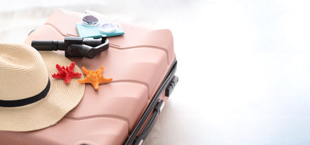 Travel flat lay items: passport, sunglasses, beach slippers and clothing on white background. Place for text. Top view. Summer conceptの写真素材