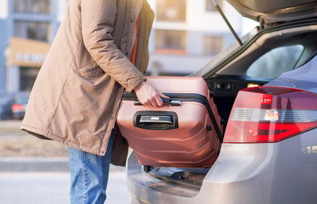 putting the suitcase in the car, luggage and travel, Travel, vacation conceptの写真素材