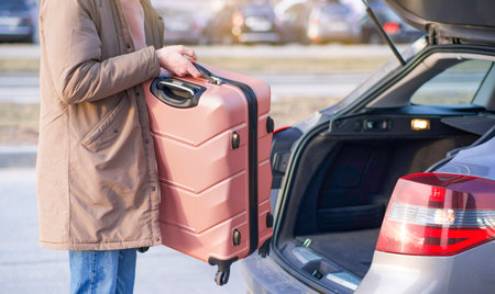 putting the suitcase in the car, luggage and travel, Travel, vacation conceptの写真素材