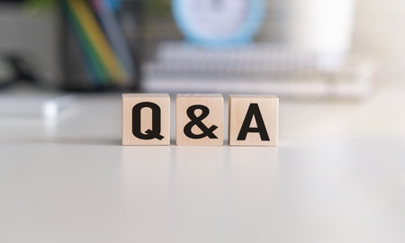 Q and A - an abbreviation of wooden blocks with letters on a gray background. Reflection of the Q and A captionの写真素材