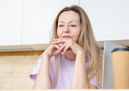 Bored tired woman working from home on her laptop. Remote worker is slow and bored in front of PCの写真素材