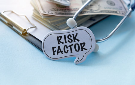 Paper with text risk factor on blue background with stethoscope and paper money dollars
